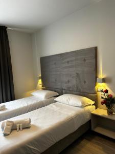 a hotel room with two beds with towels on them at PFA Hotel Ginevra - Isola d'Elba in Cavo