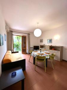 sala de estar con mesa y sofá en Appartamenti Portiglioni-Cipressi, en Puntone di Scarlino