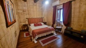 a bedroom with a bed with red pillows in it at VallettaCharme - 2 bedrooms Flat in the heart of the city in Valletta