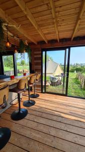a wooden deck with a table and chairs and a tent at De luxe overkapping in Middelburg