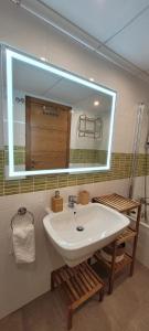 a bathroom with a sink and a large mirror at Beachfront Apartment La Manga in La Manga del Mar Menor