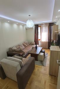 a living room with a couch and a table at Kalina Apartment in Dušanovac (historical)
