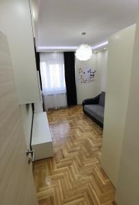 an open door to a living room with a wooden floor at Kalina Apartment in Dušanovac (historical)