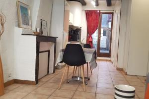 a chair in a room with a fireplace and a bed at Studio Orléans Châtelet in Orléans