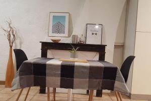 a dining room table with a black and grey table cloth at Studio Orléans Châtelet in Orléans