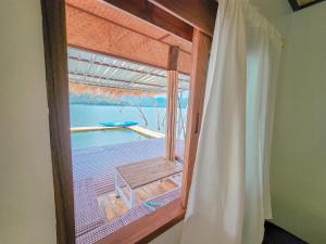 a room with a window with a view of the ocean at Hometown Riverview - โฮมทาวน์ ริเวอร์วิว in Si Sawat