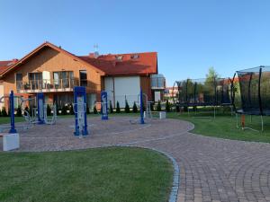 a park with a playground with swings at Apartament Premium Łeba in Żarnowska