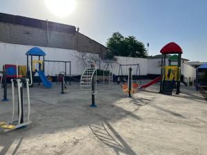 a playground with a bunch of swings and slides at Comfortable 2-roomed apartment Ozod Apartments SU2 in Samarkand