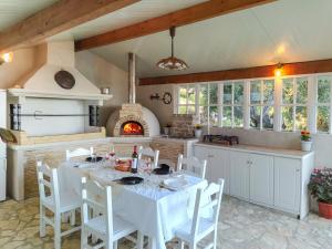 a kitchen with a table and a fireplace at Blue sky loft by Corfuescapes in Spartýlas
