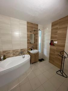 a bathroom with a bath tub and a sink at Apartmán Miriam in Nitra +48 photos