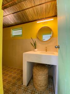 a bathroom with a sink and a mirror at Banana Surf House in Arugam Bay