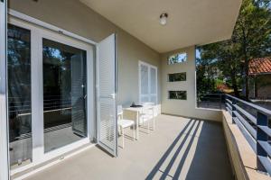 a patio with a table and chairs on a balcony at Studio Apartment Stela in Vrboska