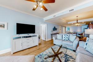 a living room with a flat screen tv and a couch at Holiday Isle 715 in Dauphin Island