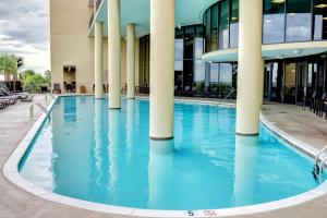 a pool in front of a building with columns at Holiday Isle 715 in Dauphin Island