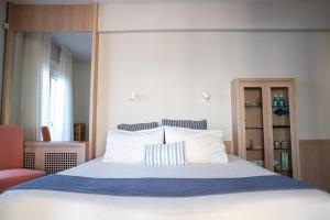 a bedroom with a large bed with white sheets and pillows at Salty Breeze Premium Stay in Perea