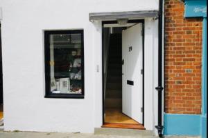 an open door of a building with a window at Apartment with Roof Terrace - Centre of Yarmouth in Yarmouth