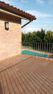 a patio with a fence and a swimming pool at Hotel Restaurante Comendador Añon de Moncayo in Añón