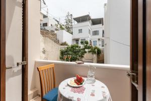 a table with a plate of fruit on a balcony at Amaranto Naxos in Naxos Chora