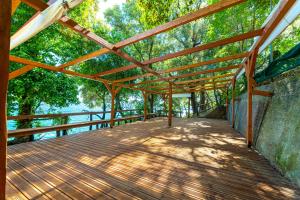 a wooden boardwalk with a wooden roof and trees at SunRiseStudiosPapanero in Damouchari