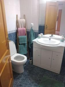 a bathroom with a toilet and a sink at Navigation House in Sesimbra