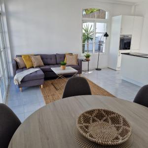 a living room with a couch and a table at Nora Retreat (Fully Renovated) in Corralejo