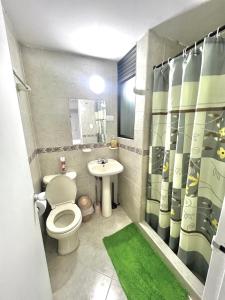 a bathroom with a toilet and a sink and a shower at APARTAMENTO 401 MEDELLIN in Medellín