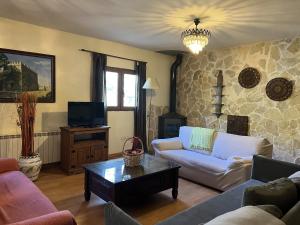 a living room with a couch and a coffee table at Las Tejeruelas Casa Rural in Navacepedilla de Corneja