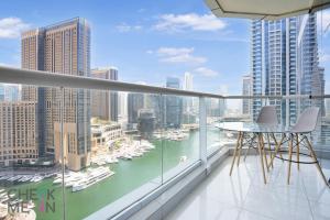 a balcony with a view of the water and boats at Luxury 2BR with Breath-taking Dubai Marina Views in Dubai