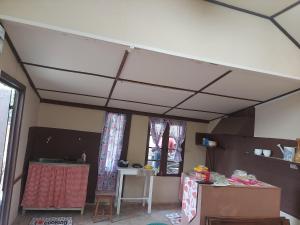 um quarto com um tecto branco e uma mesa em GIFTLAND HOMESTAY em Āīzawl
