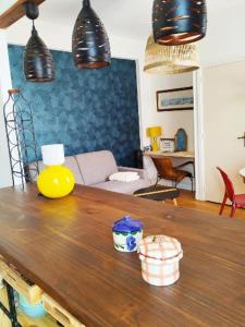 a living room with a wooden table with lights at LA TERRASSE DE NOTRE DAME in Le Havre