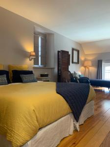 a bedroom with a large yellow bed in a room at Coté jardin in Sainte-Suzanne