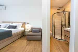 a bedroom with a bed and a shower and a sink at Apartment Vidra in Brela
