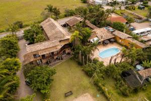 an aerial view of a house with a swimming pool at Pousada do Véio in Garopaba