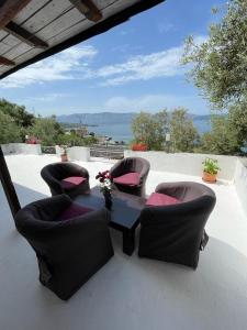 a table and chairs on a patio with a view at Marios Rooms in Vlorë