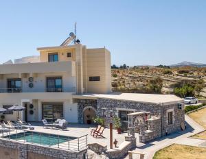 a villa with a swimming pool and a house at Des & Coo Luxury Villa with Private Pool in Faliraki