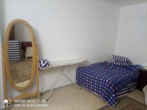 a bedroom with a mirror and a bed and a dressing table at Decapolis 200 with 3 bed room in Irbid