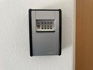 a soap dispenser is attached to a wall at Superior-Apartment mit Pool und Seezugang in Velden am Wörthersee