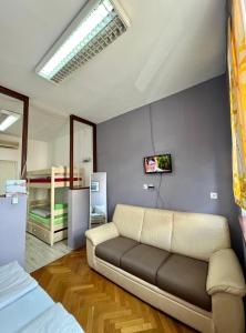 a living room with a couch and a bed at BISHNU HOSTEL in Zagreb