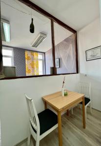a dining room with a table and a mirror at BISHNU HOSTEL in Zagreb