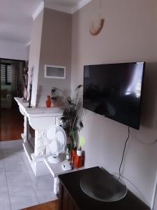 a living room with a flat screen tv on a wall at Casa Calado in Cadima