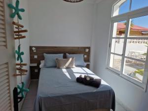 a bedroom with a bed with a teddy bear on it at Nora Retreat (Fully Renovated) in Corralejo