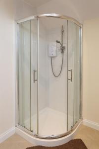 a shower with a glass enclosure in a bathroom at 3Bed/2Bath Duplex Apartment - Pure Bliss Belfast in Belfast