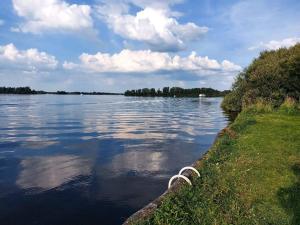 a view of a lake with a white object in the water at Tiny house ''De Veenpolder'' in De Veenhoop