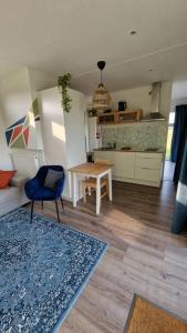 a living room with a couch and a table at Tiny house ''De Veenpolder'' in De Veenhoop