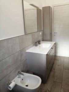 a bathroom with a white sink and a mirror at AFFITTACAMERE S.ORSOLA - MALPIGHI in Bologna