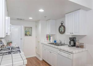 a kitchen with white cabinets and a counter top at Condo at Slide Creek in Bass Lake