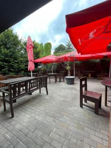 a group of tables and chairs with umbrellas at Sun-House Pension&Restaurant -ParkingFree- in Prague