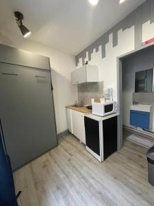 A kitchen or kitchenette at Ambert CentreVille La Studette tout confort