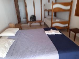 a bedroom with a large bed and two bunk beds at El Delfin in Zorritos