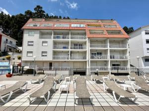 a row of chairs in front of a building at Park Raxo in Raxó